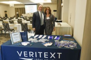 Cory Katz, Steve Reymer and the Veritext Legal Solutions' sponsor booth at Washington in the West 2019